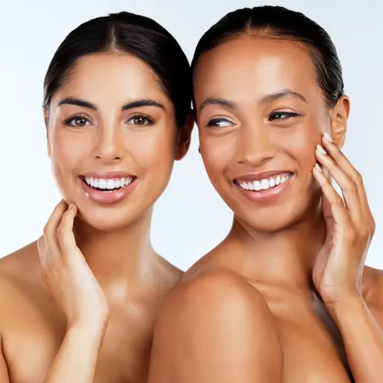 Two women with radiant skin showcasing inclusive skincare results