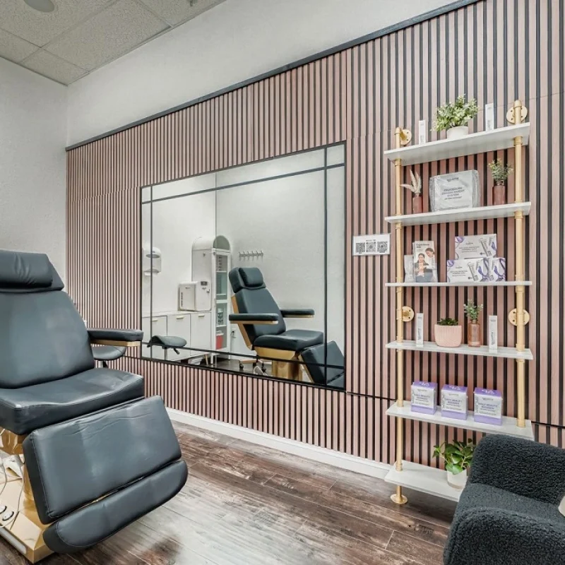 Private treatment room with reclining chair and skincare shelving